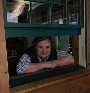 George Lenihan looking through the old food service window at Pancho O'Malley's